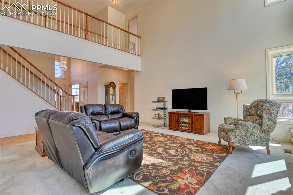 Image 15 of 47: The spacious great room has soaring vaulted ceilings.