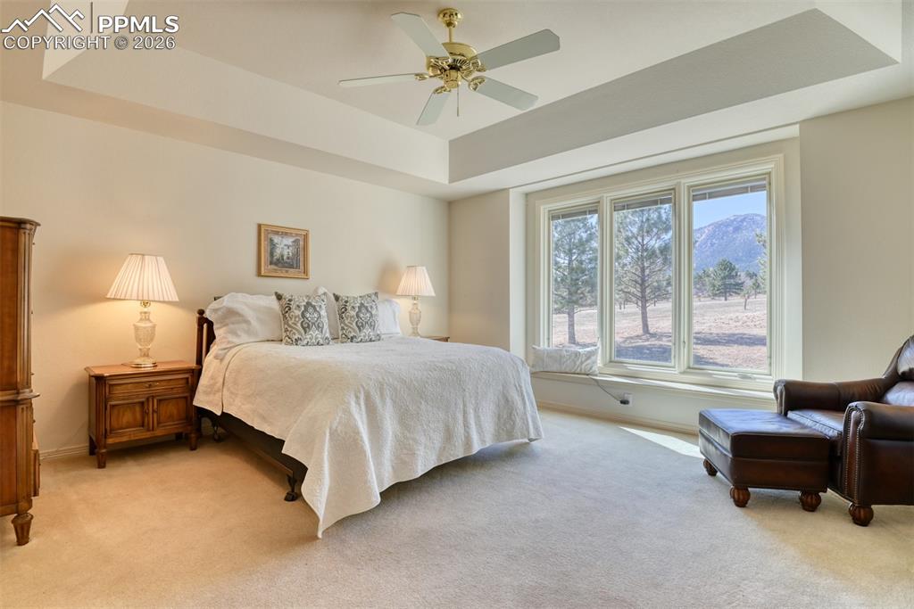 Image 18 of 47: Primary bedroom has mountain views, coffered ceiling, window seat, and Pell