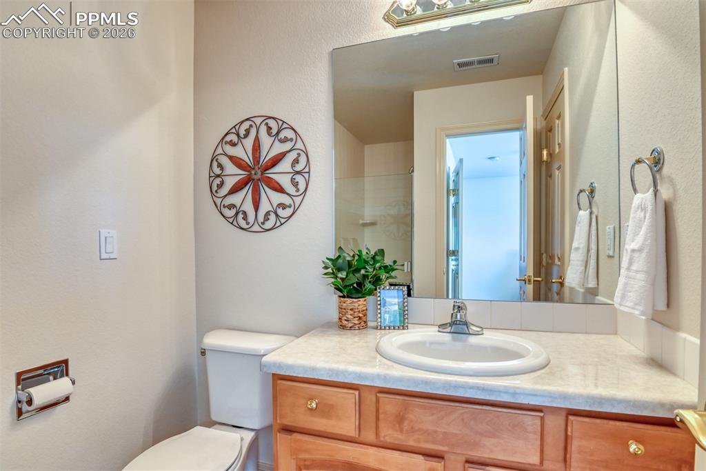 Image 26 of 47: Private 3/4 attached bathroom has linen closet on right. See shower in the 