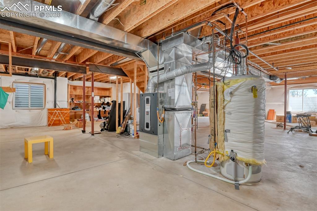 Image 42 of 47: Built in shelving for storage. Basement is roughed in for additional future