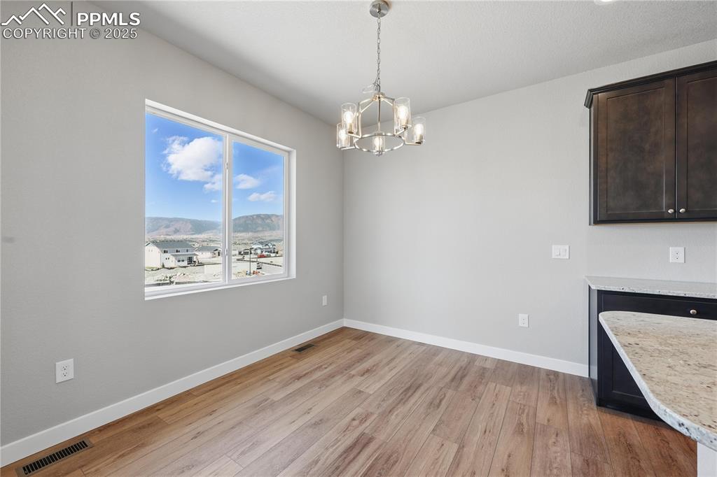 Image 14 of 36: Unfurnished dining area with a wealth of natural light, light wood-type flo
