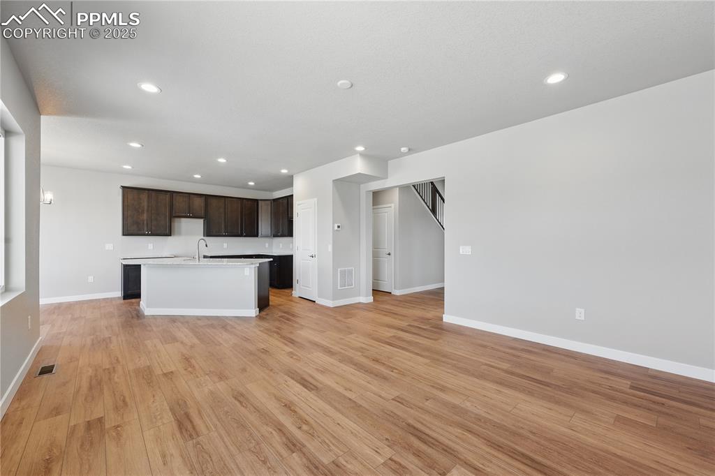 Image 18 of 36: Unfurnished living room with recessed lighting, visible vents, baseboards,