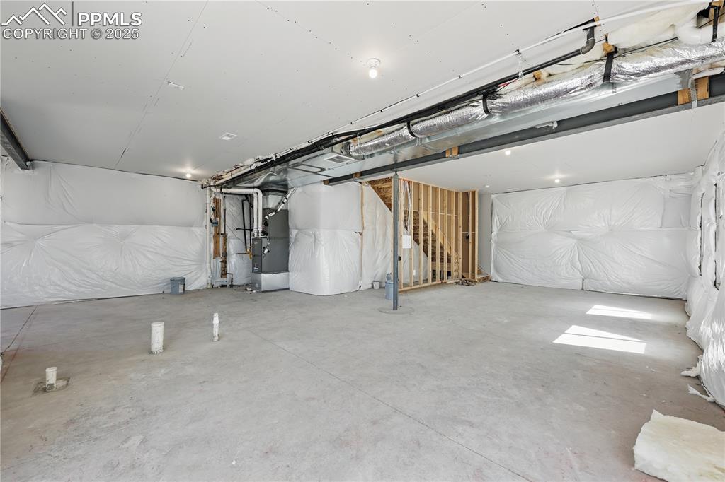 Image 34 of 36: Unfinished below grade area featuring heating unit