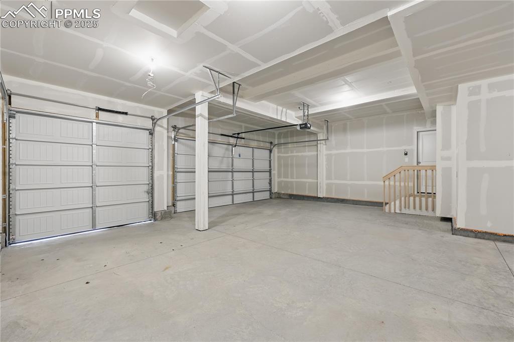 Image 36 of 36: Garage featuring a garage door opener