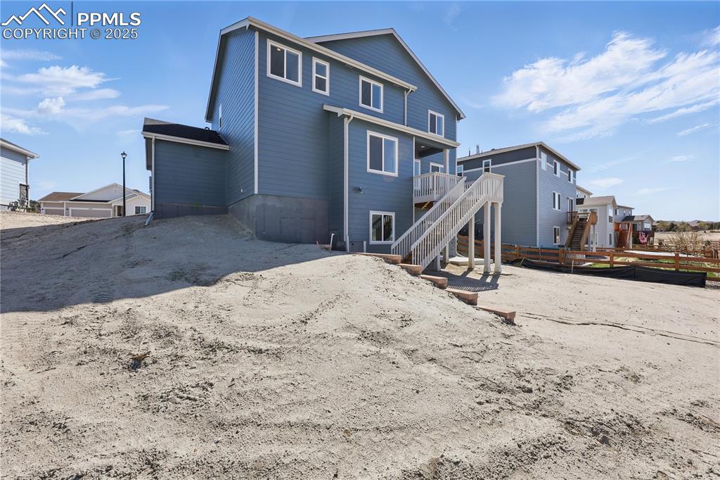 Image 9 of 36: Back of property featuring fence, a deck, and stairs