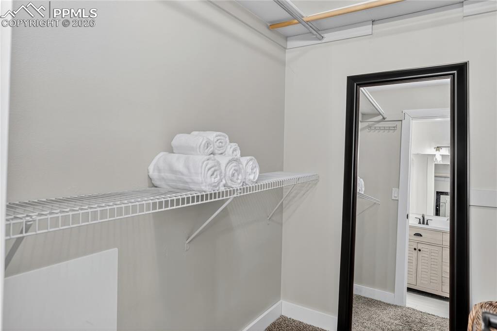 Image 17 of 32: Primary walk-in closet