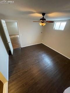 Image 19 of 25: Unfurnished bedroom featuring a ceiling fan and dark wood-type flooring