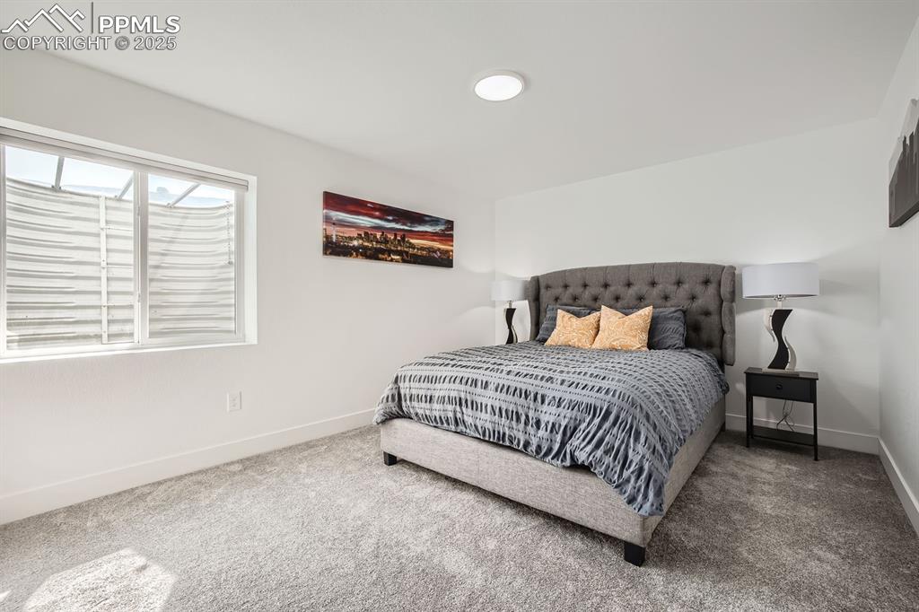 Image 23 of 31: Carpeted bedroom with baseboards