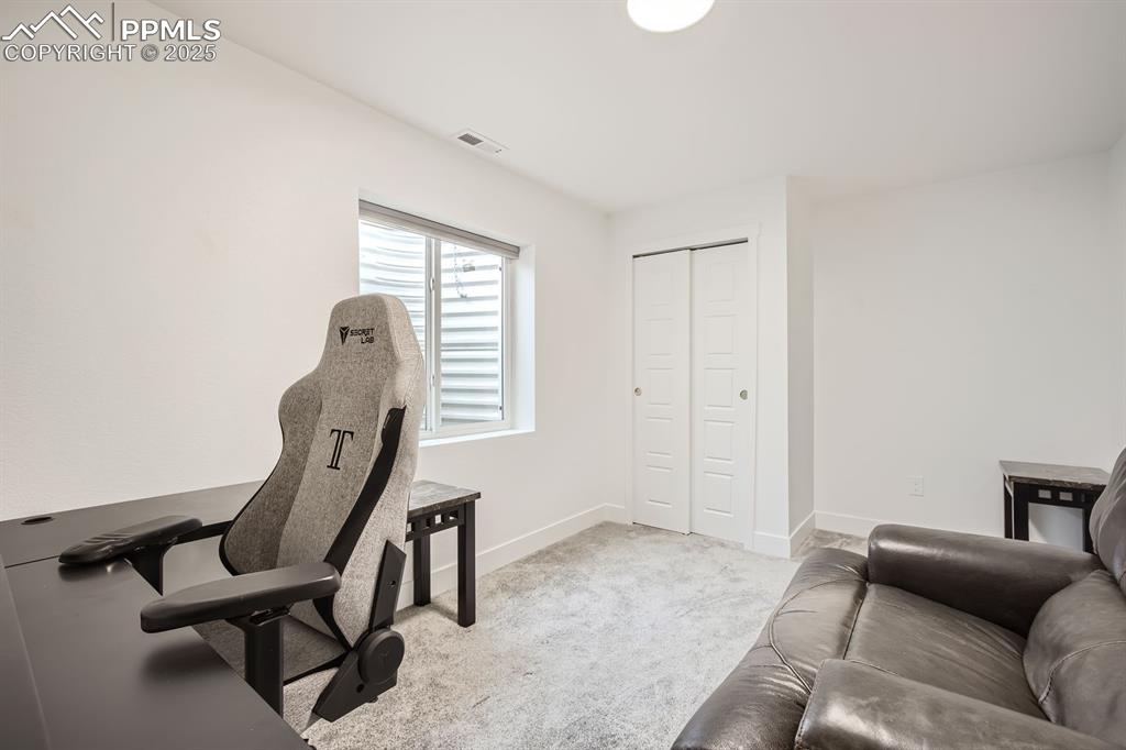 Image 26 of 31: Office area with light carpet and baseboards