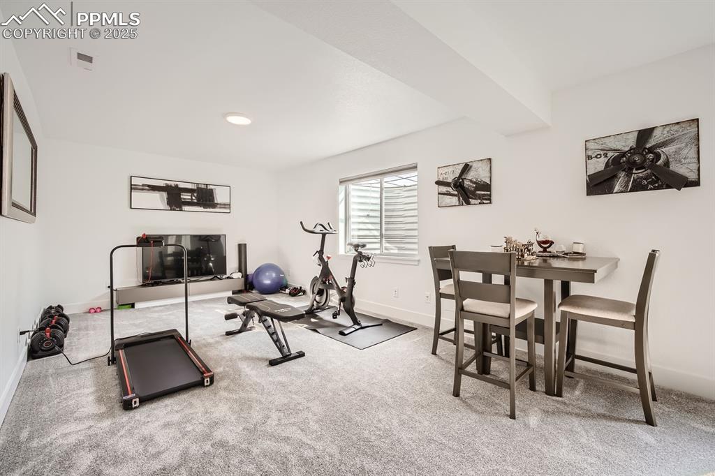 Image 27 of 31: Exercise area with carpet floors and baseboards