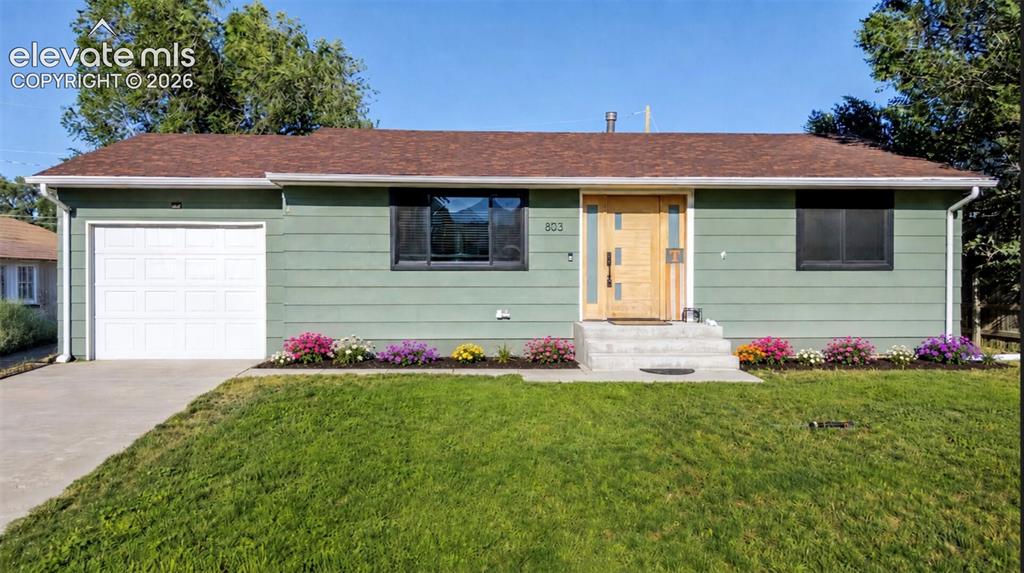 Image 1 of 49: Ranch-style exterior featuring sage green siding, a brown shingled roof, an