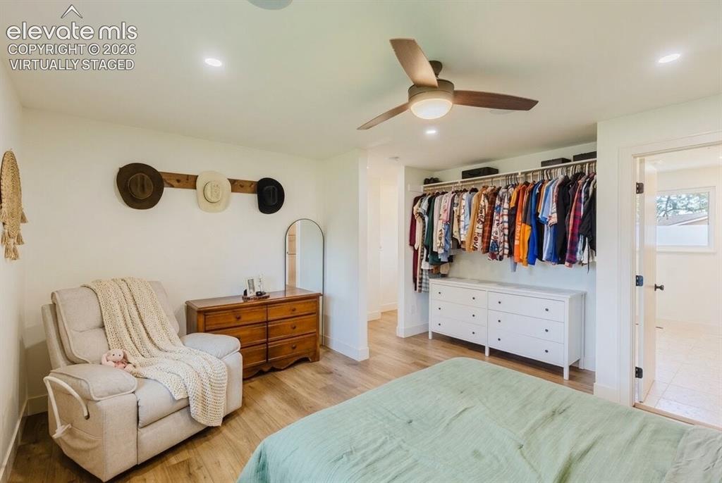 Image 11 of 49: Spacious room featuring wood-finish flooring, recessed lighting, and a ceil