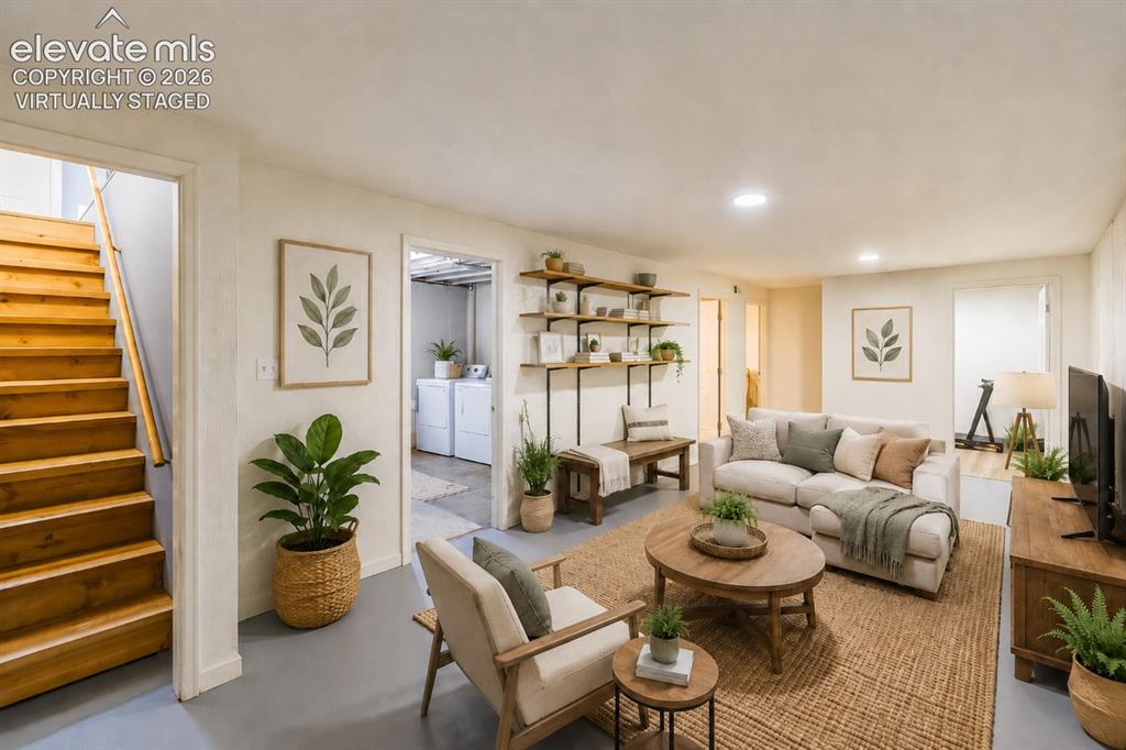 Image 16 of 49: Finished living space featuring wood-finish stairs, recessed lighting, buil