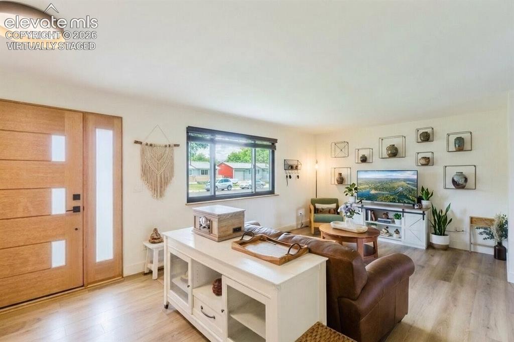 Image 2 of 49: Light wood-finish flooring extending throughout the space (virtually staged