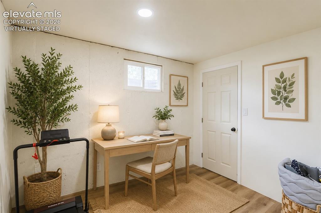 Image 20 of 49: Finished room featuring recessed lighting, a multi-pane window, wood-finish