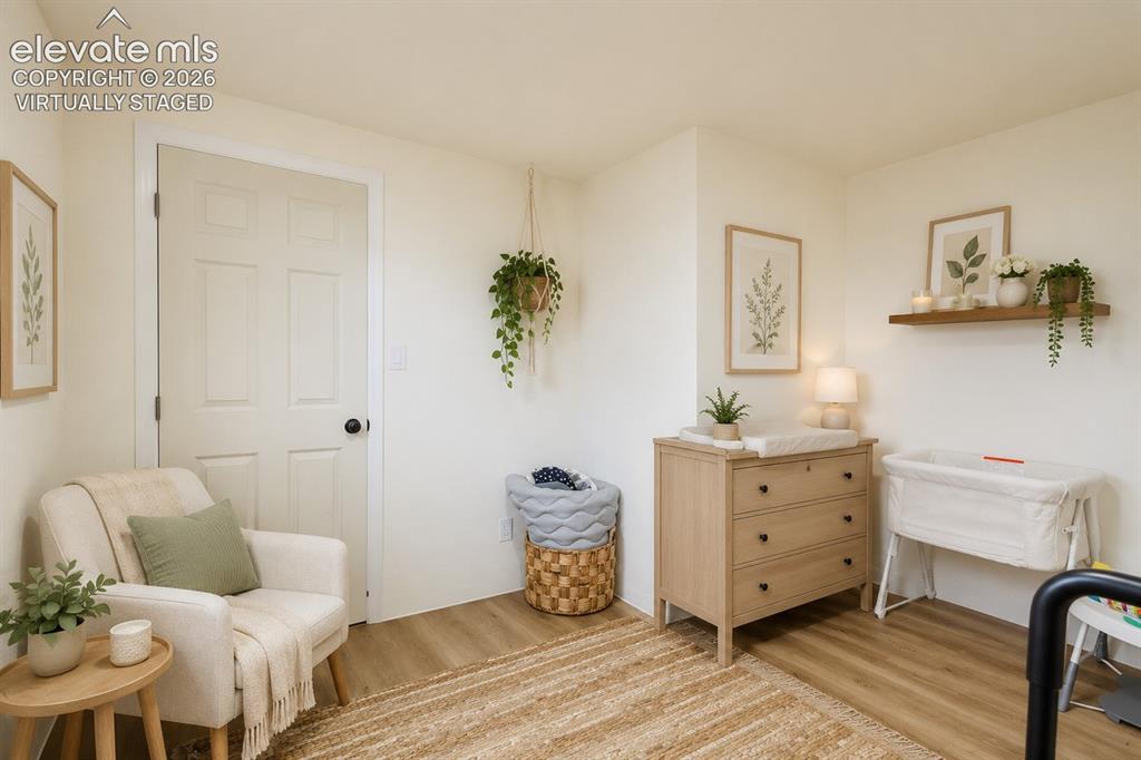 Image 21 of 49: Room featuring light-colored walls and wood-finish flooring (virtually sta