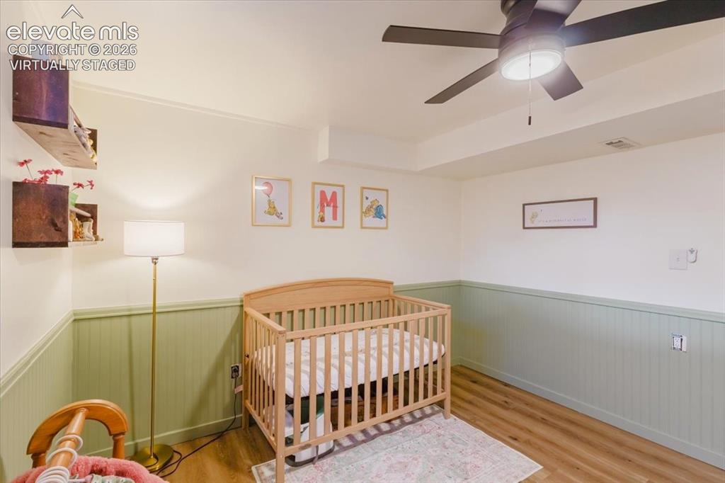 Image 24 of 49: Room featuring wood-finish flooring, a contemporary ceiling fan with integr