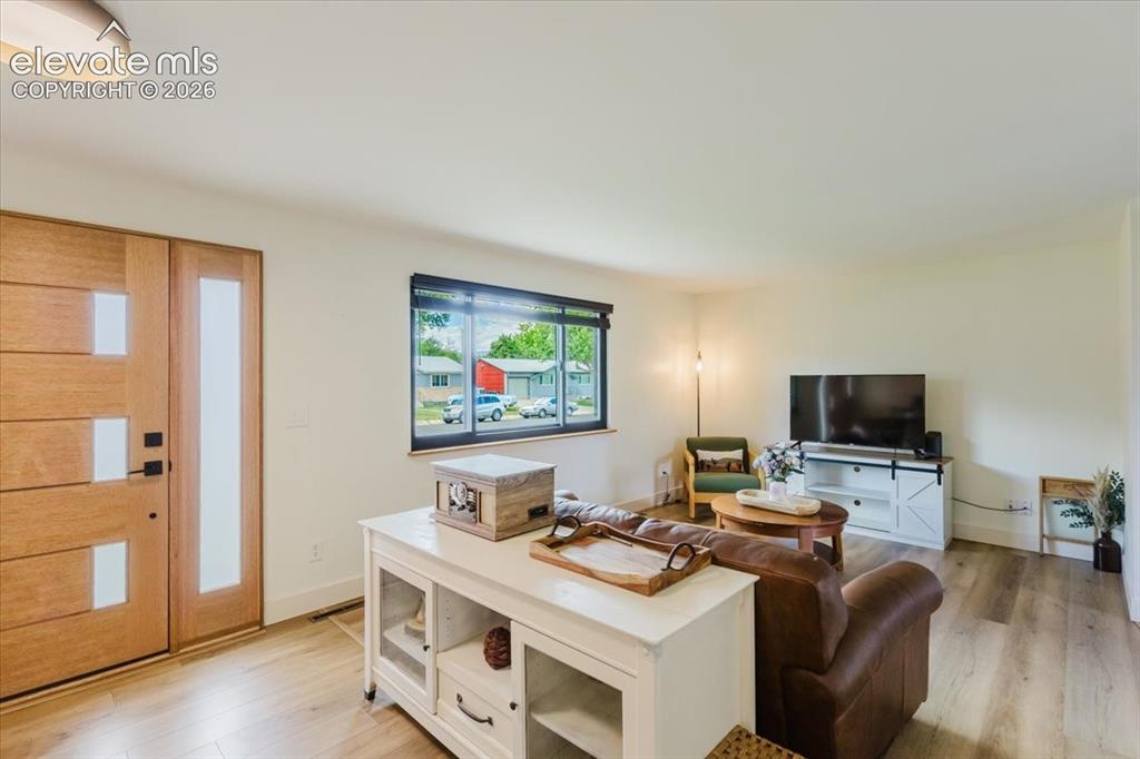 Image 29 of 49: Entryway featuring a contemporary wooden door with frosted glass inserts, w