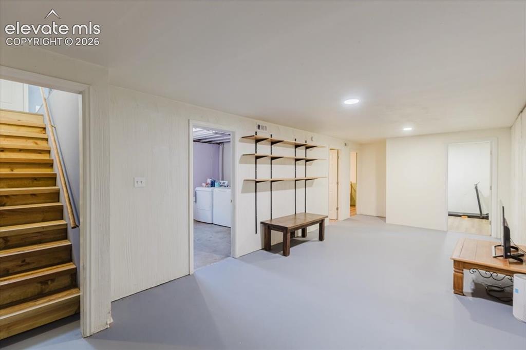 Image 43 of 49: Spacious lower level featuring a light gray floor, recessed lighting, and w