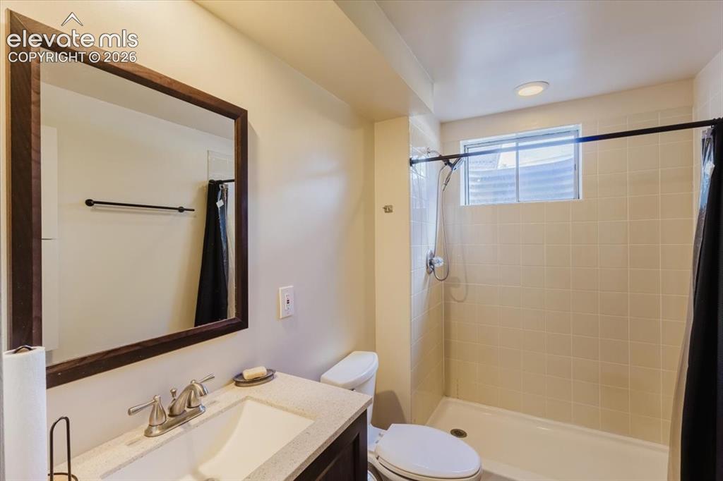 Image 47 of 49: Full bathroom featuring a rectangular vanity sink with a brushed nickel fau
