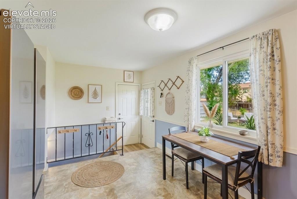 Image 6 of 49: Bright interior space featuring a large window, light-toned flooring, a fro