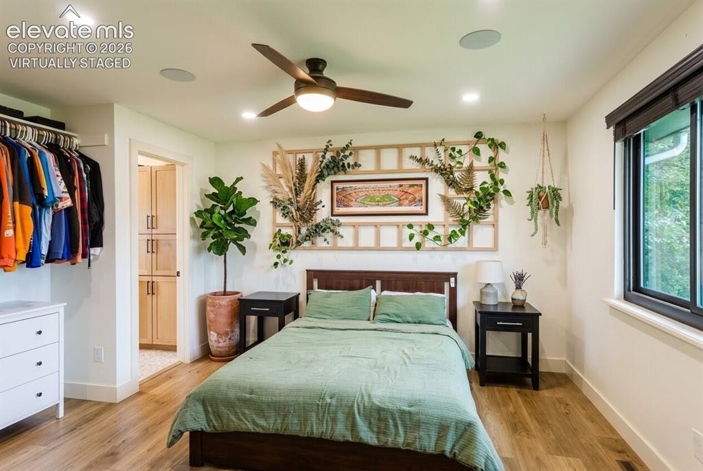 Image 9 of 49: Bedroom featuring wood-finish flooring, a ceiling fan with integrated light