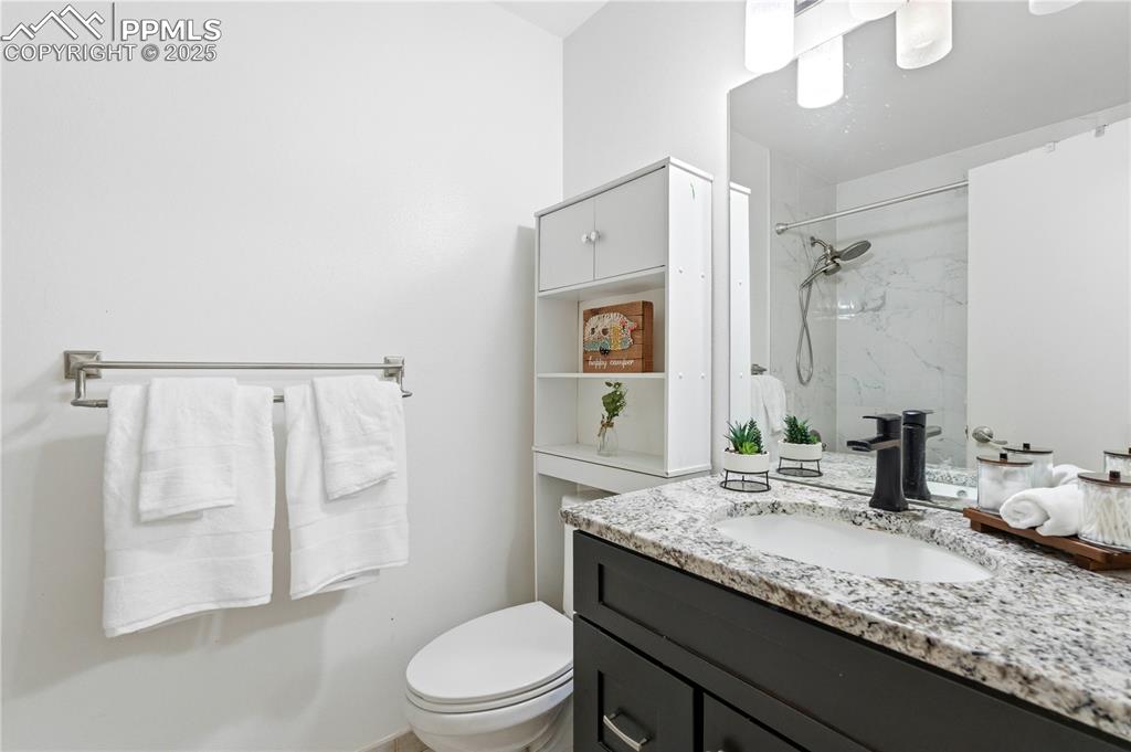 Image 18 of 31: Full bathroom featuring vanity and a marble finish shower