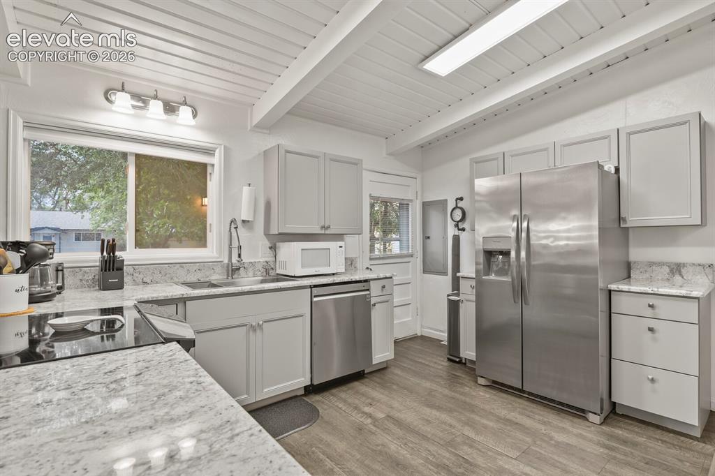 Image 11 of 37: View of kitchen from backdoor looking towards living room and entrance.
