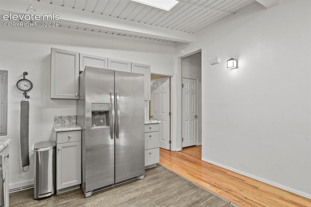 Image 12 of 37: Kitchen from hallway looking toward dining room and entrance.