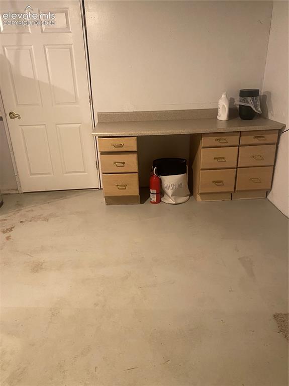 Image 20 of 30: Laundry area looking towards door to basement bedroom.
