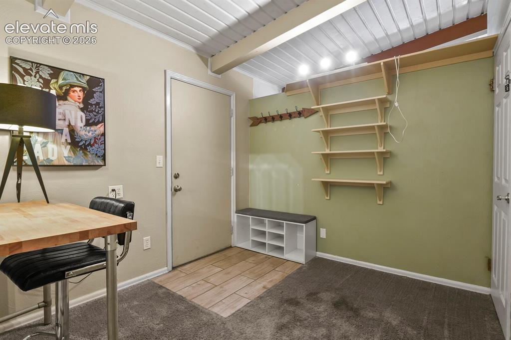 Image 20 of 37: Living room area from far corner looking at TV area and dining/card/game ta