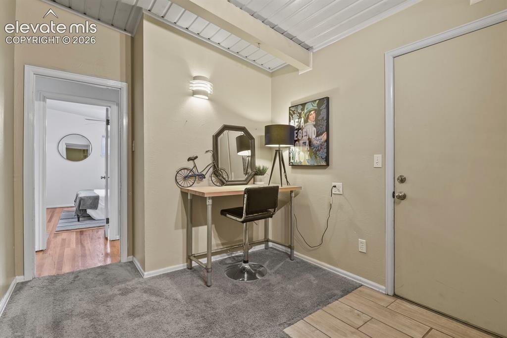 Image 21 of 37: Corner of Family room looking towards stairs and door to one of the basemen
