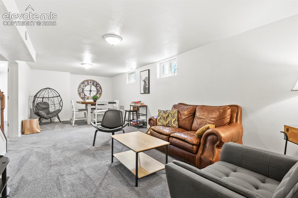 Image 22 of 37: TV area in Family Room, looking towards second basement bedroom.