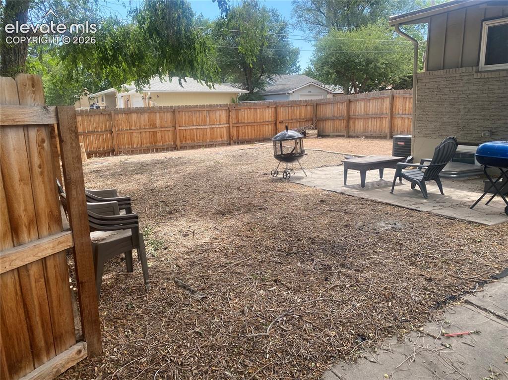 Image 24 of 30: Fenced backyard from front-side corner.