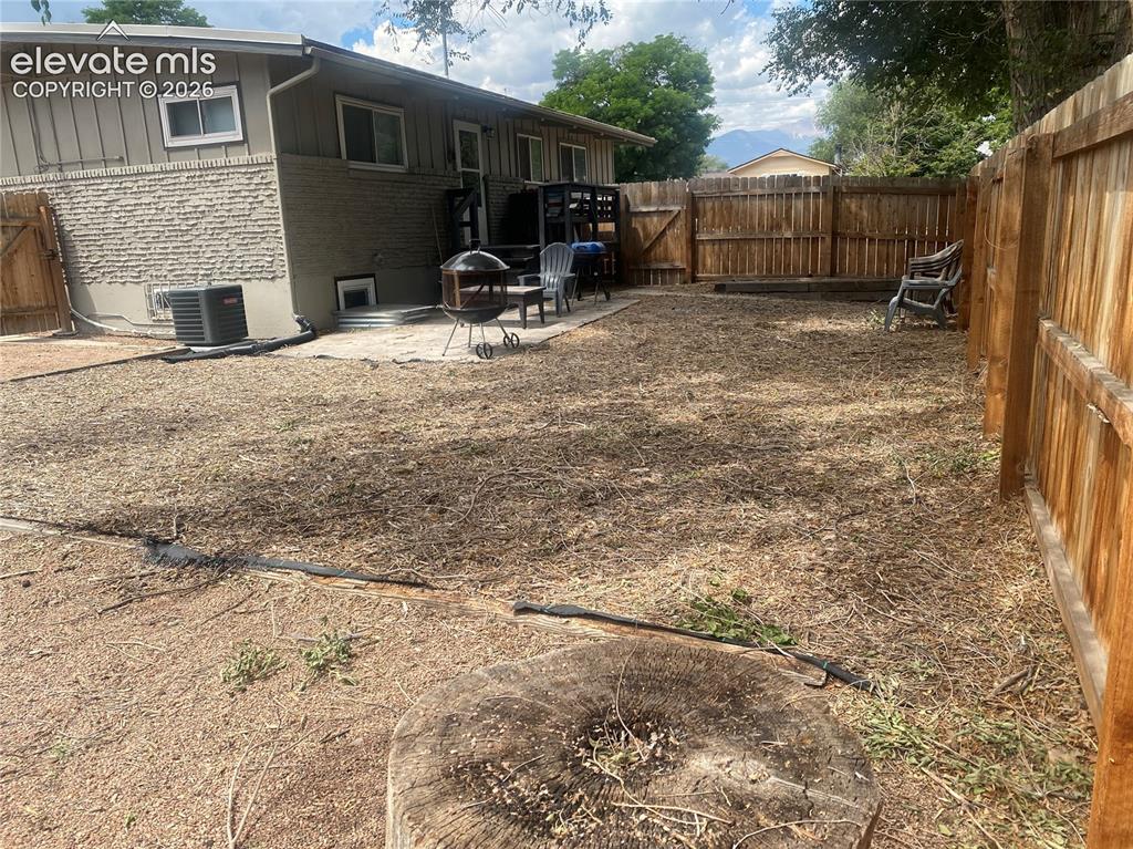 Image 25 of 30: Fenced backyard from far side corner.