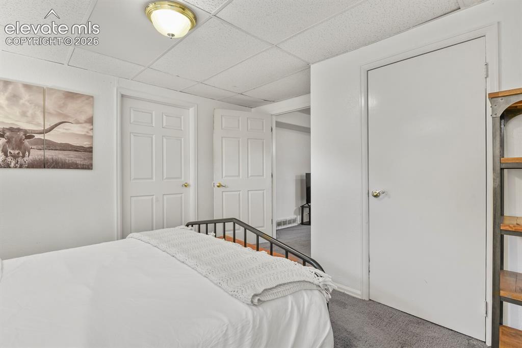 Image 27 of 37: Basement bedroom with small office area and egress window installed to code