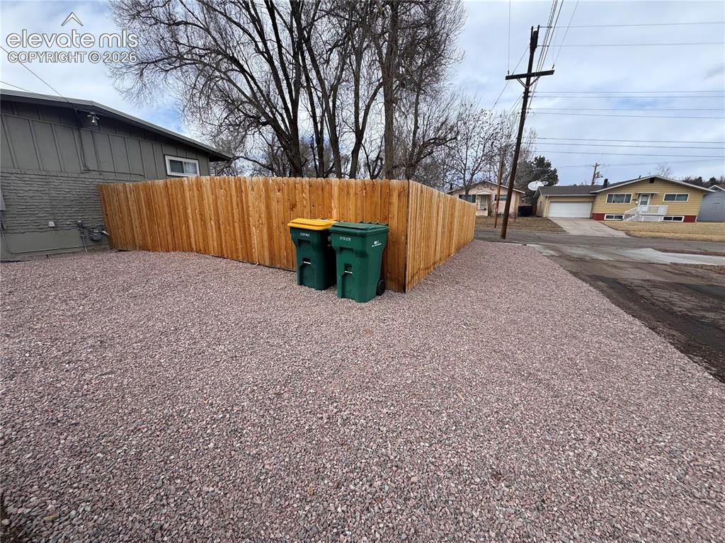 Image 28 of 30: RV Parking to the rear/side of the house, outside the gate.