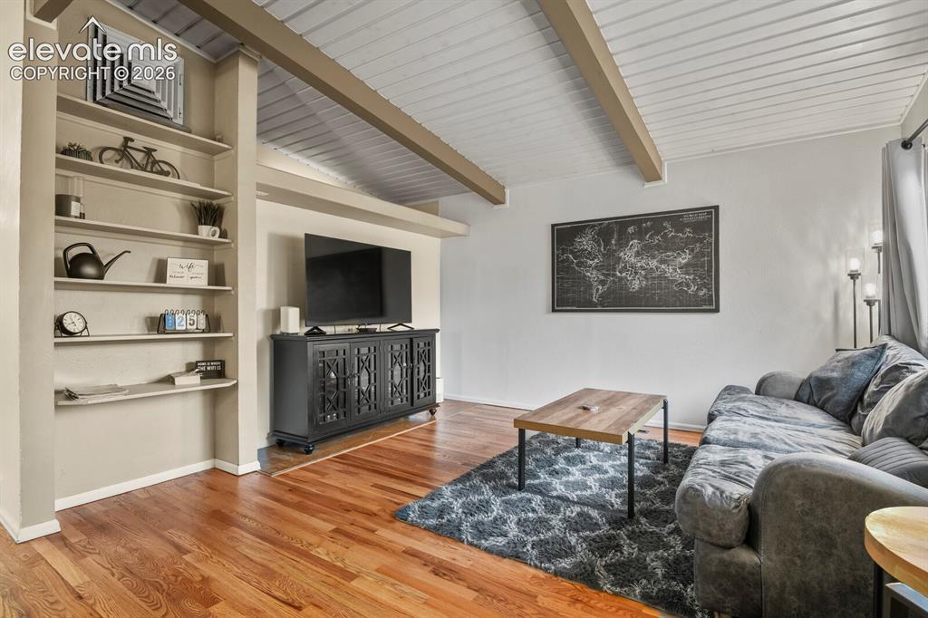 Image 5 of 37: Living room looking toward the entrance and dining area.