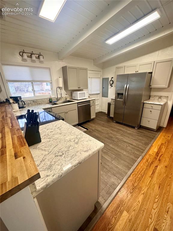 Image 6 of 30: Kitchen area looking towards the back door.