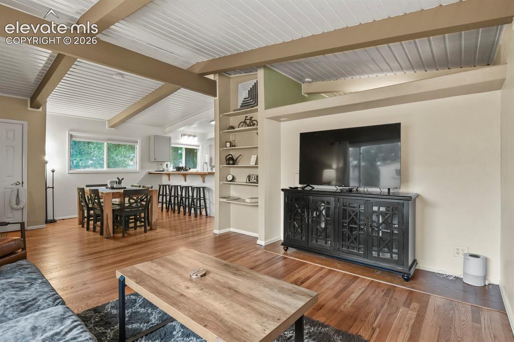 Image 8 of 37: Dining area with view of tongue-in-groove ceiling, living room, and entranc