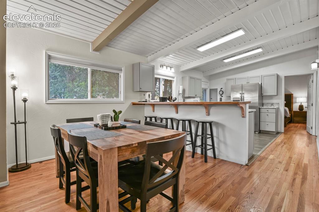 Image 9 of 37: Kitchen from corner of breakfast bar looking towards door to the patio and