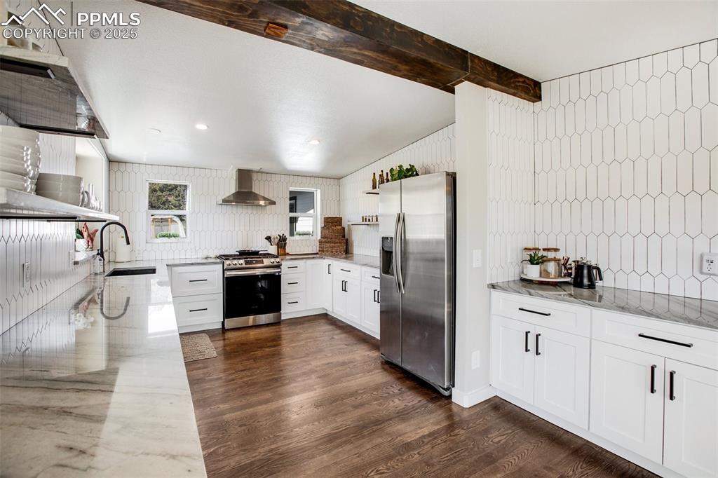 Image 12 of 50: Kitchen with breakfast/coffee bar