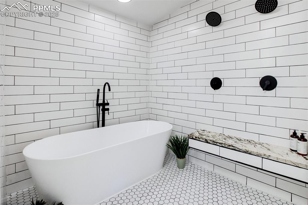 Image 19 of 50: Primary ensuite bathroom with dual showerheads and soaking tub