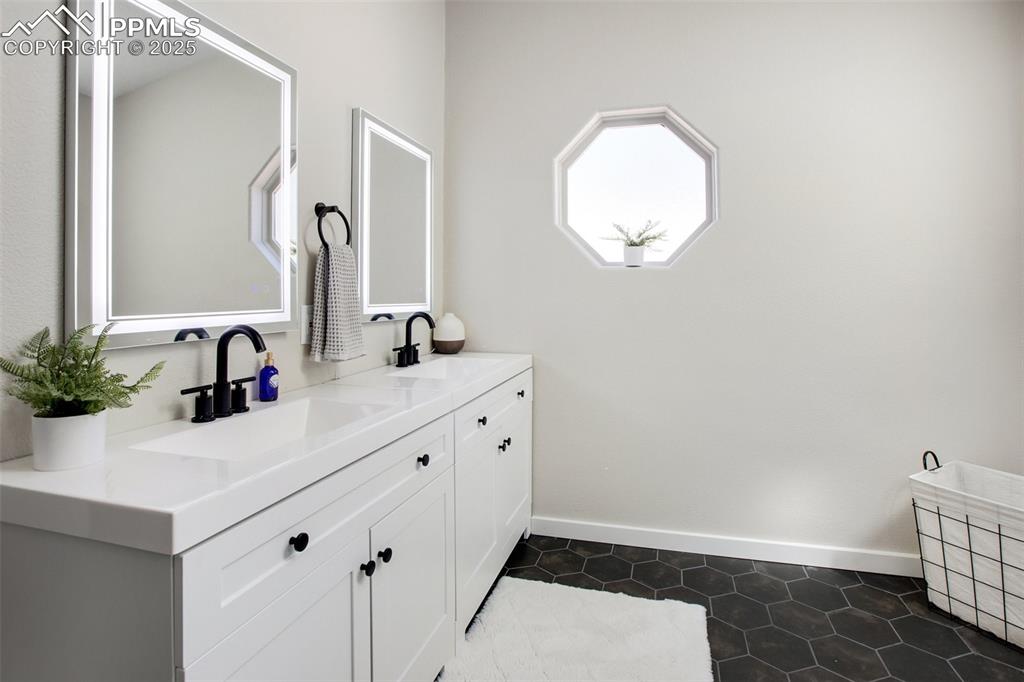 Image 20 of 50: Primary bathroom with double vanities 