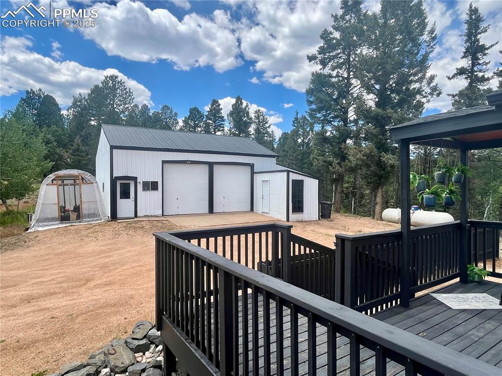 Image 39 of 50: Oversized detached garage with extra storage areas