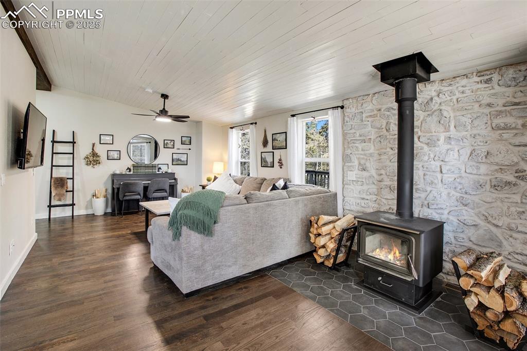 Image 4 of 50: Main level living room with wood burning fireplace