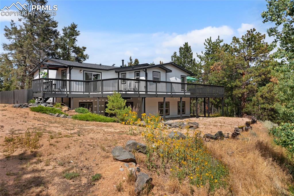 Image 45 of 50: Back of property with a wooden deck