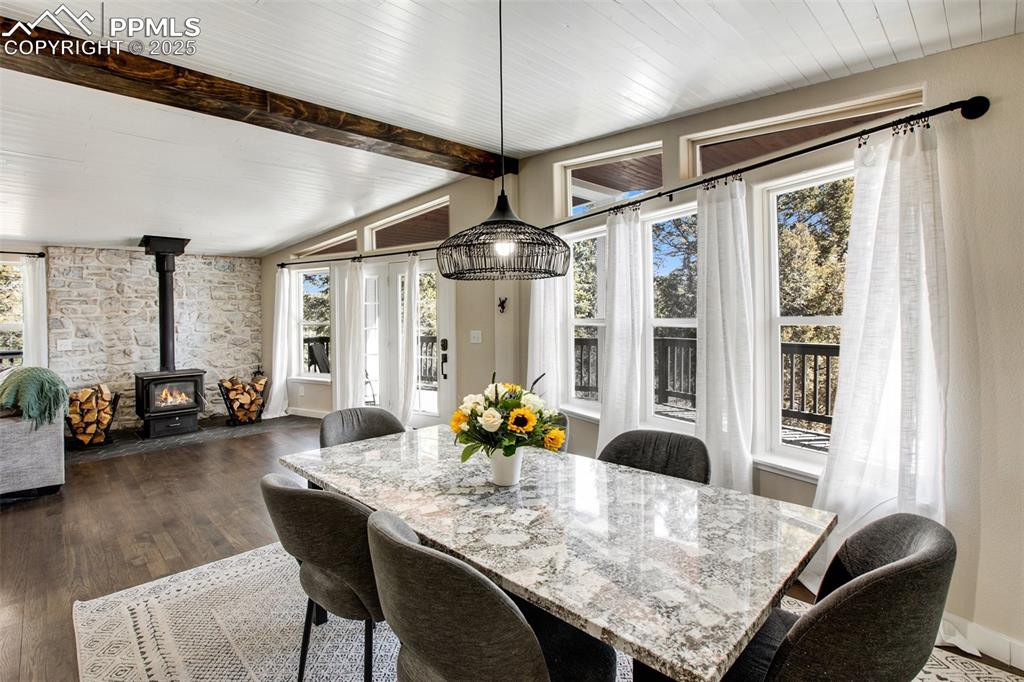 Image 7 of 50: Main level dining room with walkout to wraparound deck