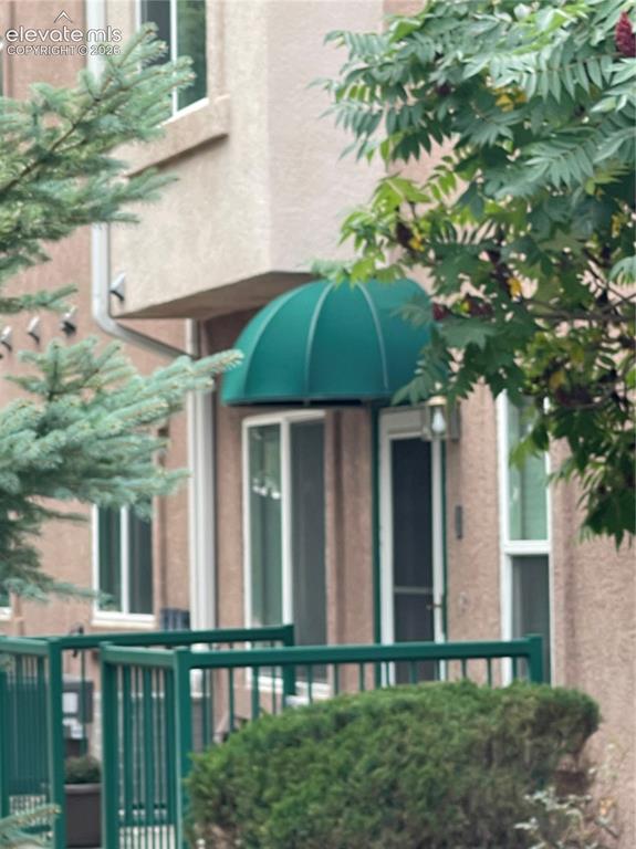 Caption: Front Entrance with Canopy over fenced Patio