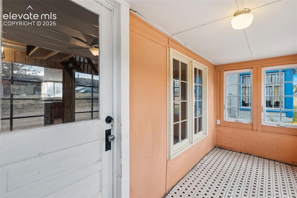 Image 4 of 45: Bright, sunny sunporch entry